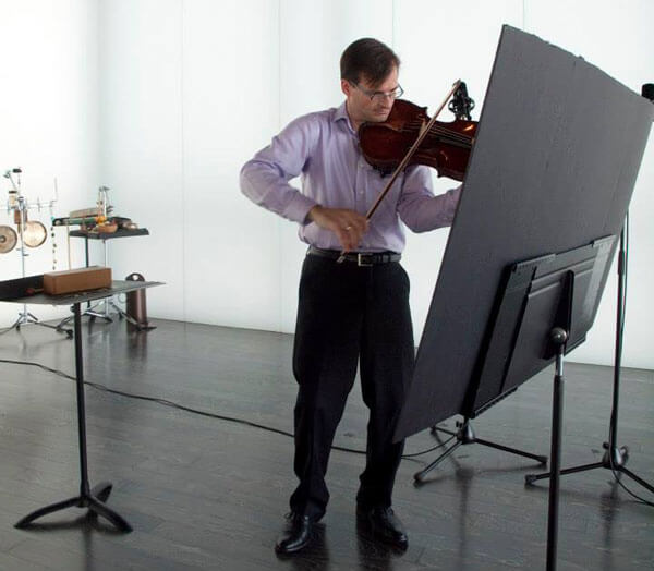 Violist Michael Hall with composer Matthew Burtner's oversized score (photo credit: Stephen Butler)