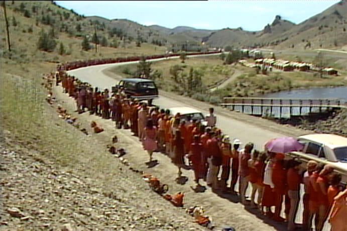 Rajneeshees lined up to greet Osho in Rajneeshpuram - Archival still