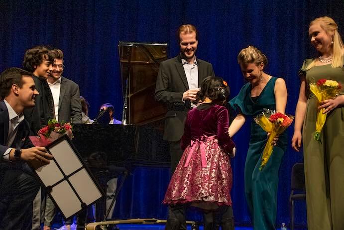 Young poet Nina Szabo greets performers at a 2020 LYNX Project concert--Photo by Kate Hursh